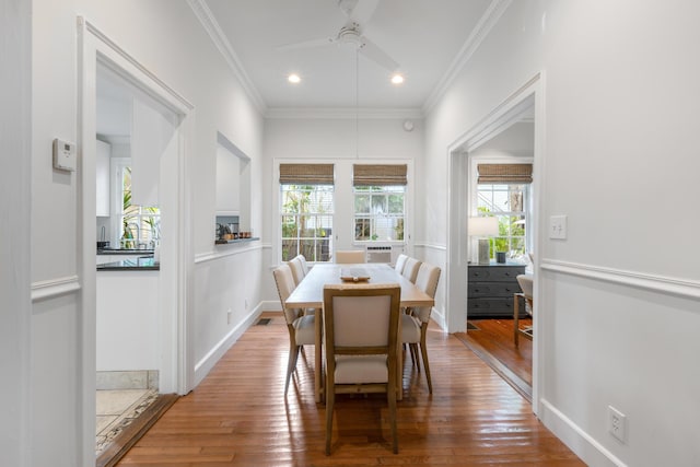 dining room featuring crown molding, ceiling fan, and wood-type flooring