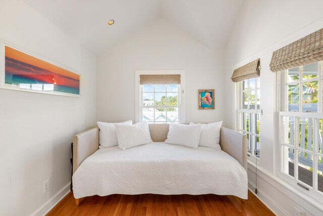 bedroom featuring hardwood / wood-style flooring and lofted ceiling