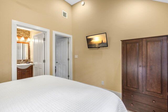 bedroom with sink and ensuite bathroom