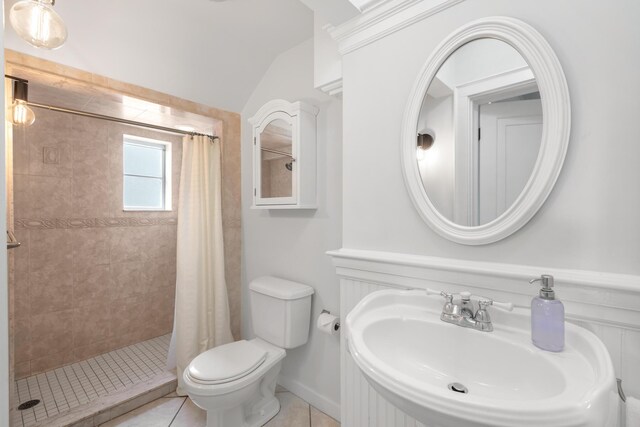 bathroom featuring walk in shower, tile patterned floors, toilet, and sink