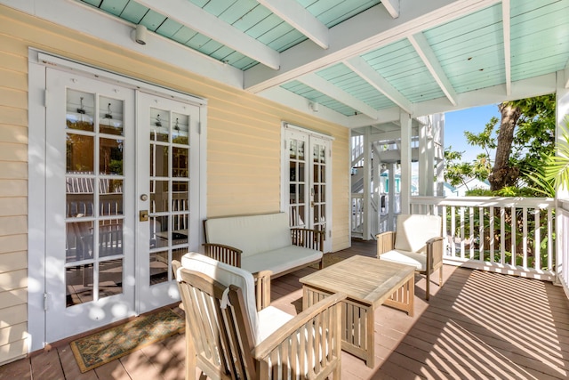 wooden deck featuring outdoor lounge area and french doors