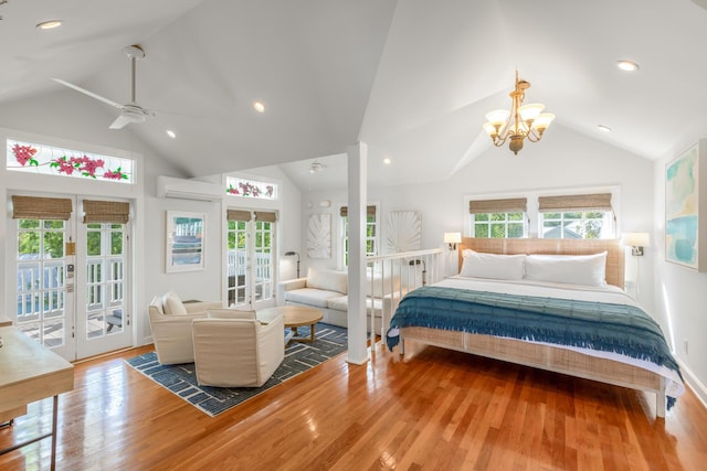 bedroom featuring french doors, wood-type flooring, a wall mounted AC, and access to outside