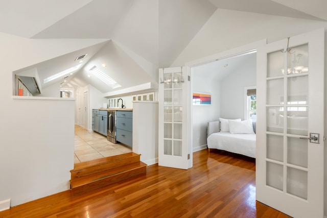 interior space featuring lofted ceiling and light wood-type flooring