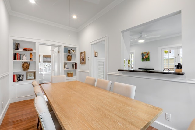 dining space featuring crown molding, ceiling fan, and hardwood / wood-style flooring