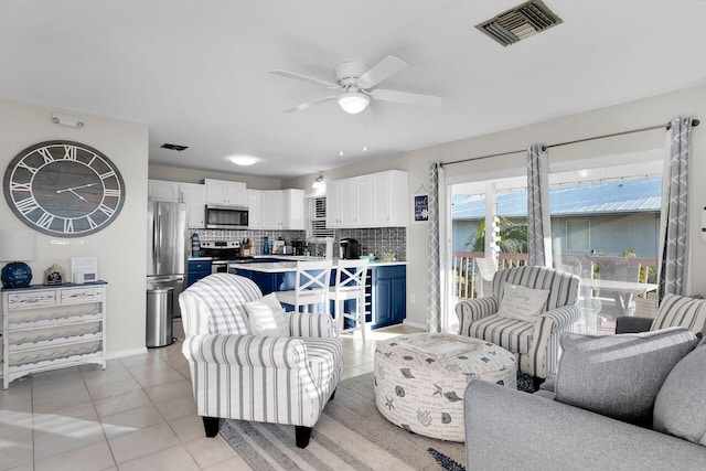 living room featuring ceiling fan and light tile patterned flooring