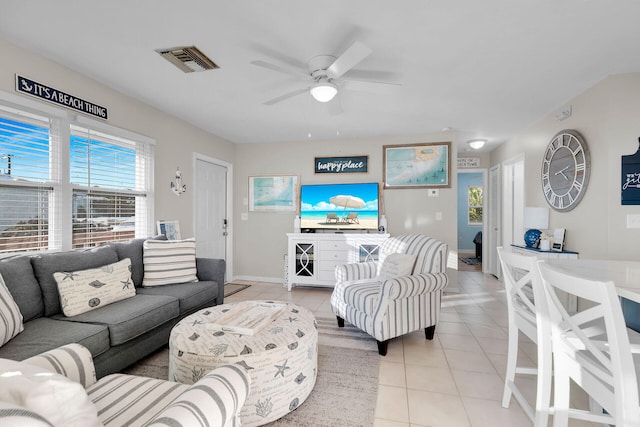 tiled living room featuring ceiling fan