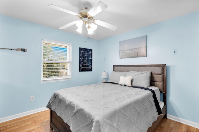 bedroom featuring hardwood / wood-style flooring and ceiling fan