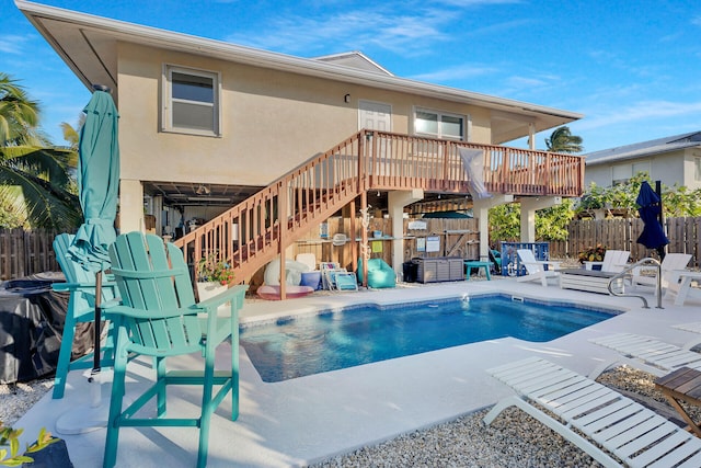 view of swimming pool featuring a deck and a patio