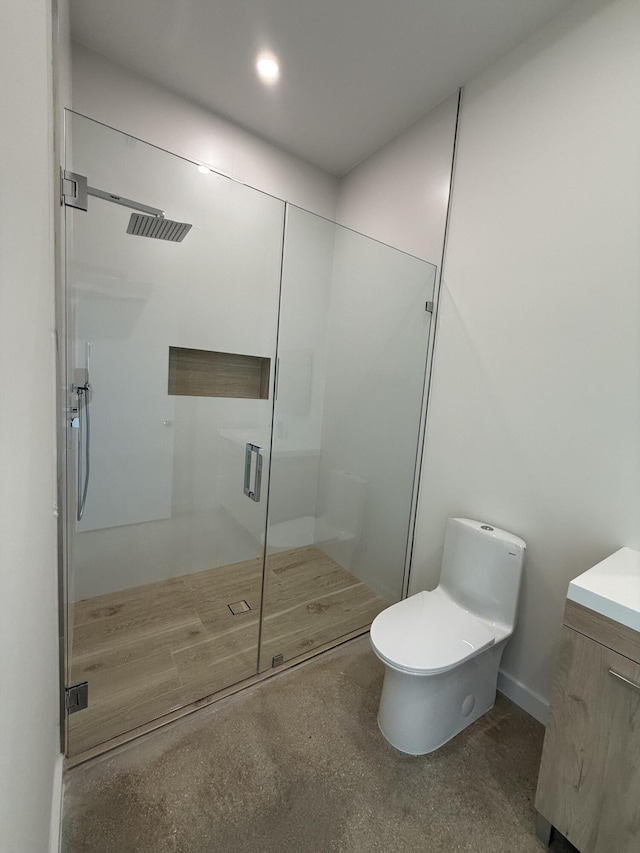 bathroom with vanity, toilet, and walk in shower