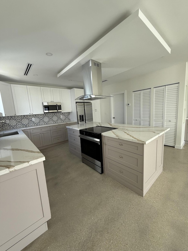 kitchen featuring gray cabinets, island exhaust hood, light stone counters, and electric stove