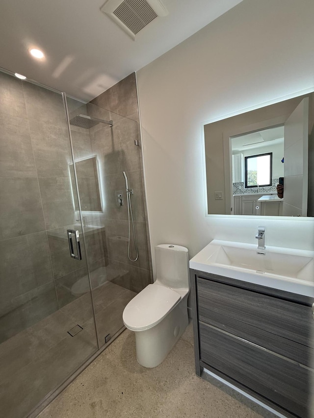 bathroom with vanity, toilet, and an enclosed shower