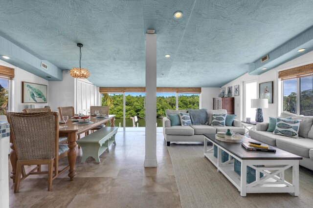 living room with a notable chandelier and a textured ceiling