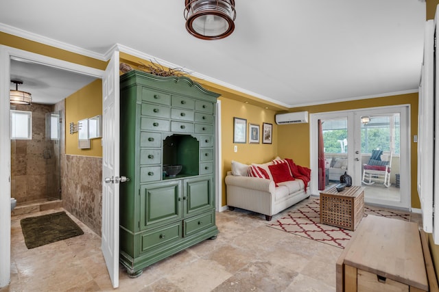 living room featuring ornamental molding, a wall unit AC, and french doors