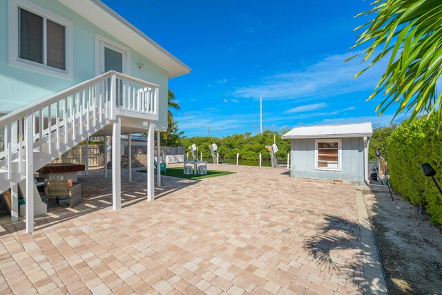 view of patio with an outbuilding