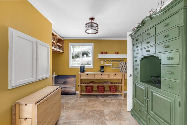 kitchen featuring crown molding and green cabinetry