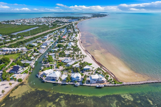 aerial view with a water view and a beach view