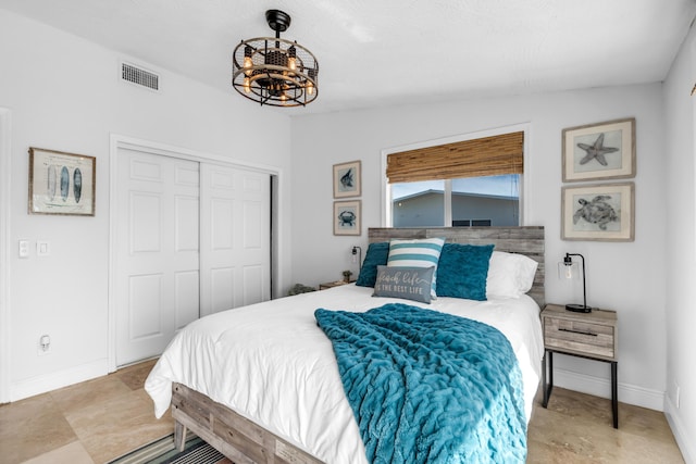 bedroom featuring an inviting chandelier, vaulted ceiling, and a closet