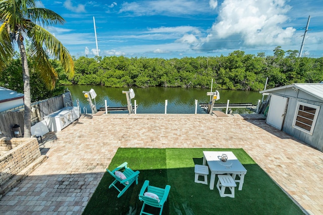 view of patio / terrace featuring a water view and a boat dock