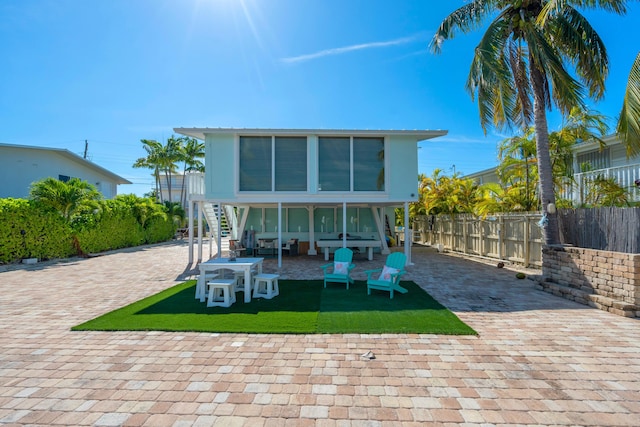 rear view of property featuring a lawn