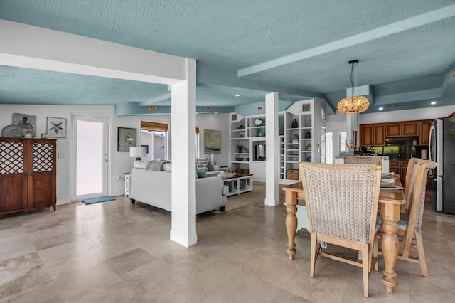 dining space featuring a notable chandelier and a textured ceiling