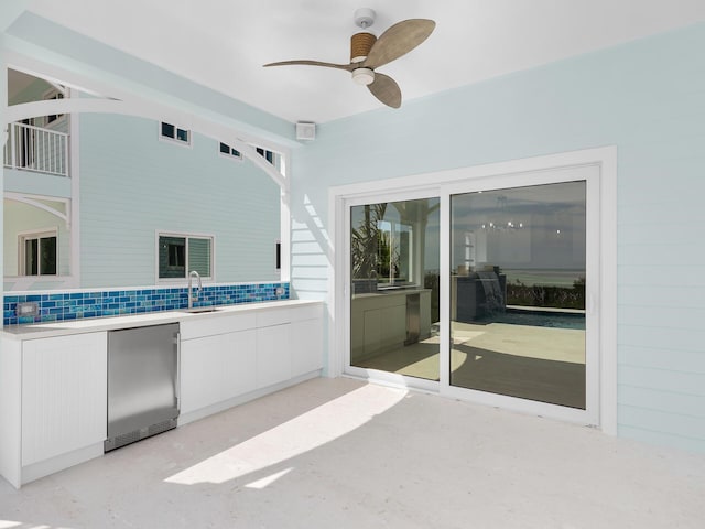 view of patio with ceiling fan and sink