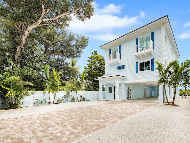 view of front of house featuring a carport and a balcony