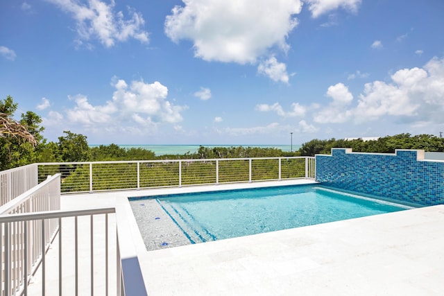 view of swimming pool featuring a water view