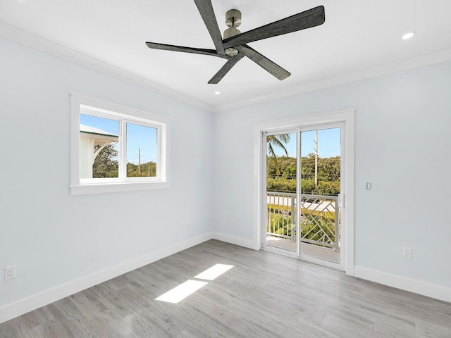 empty room with crown molding, ceiling fan, and light hardwood / wood-style floors