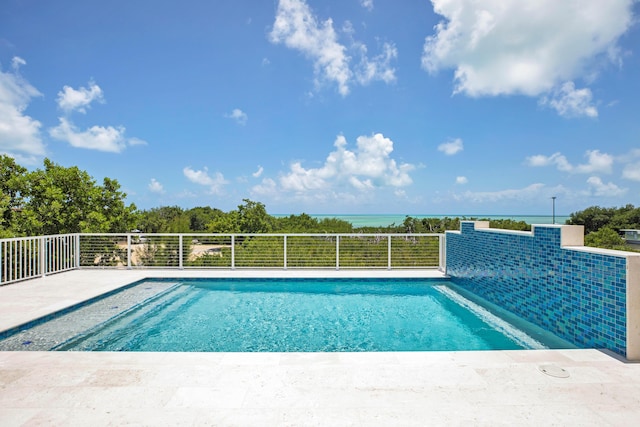 view of swimming pool featuring a water view