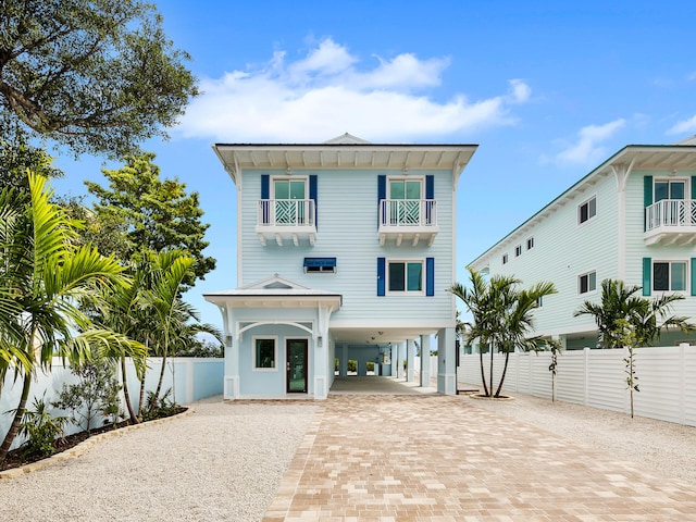 view of front facade with a carport and a balcony