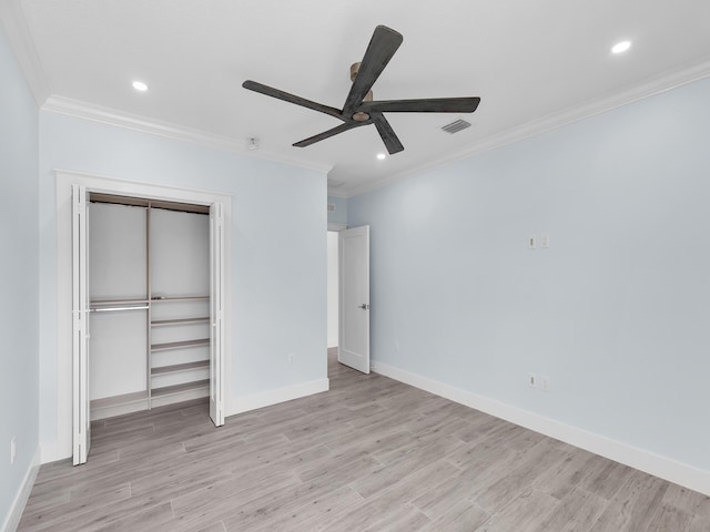 unfurnished bedroom featuring crown molding, a closet, ceiling fan, and light hardwood / wood-style flooring