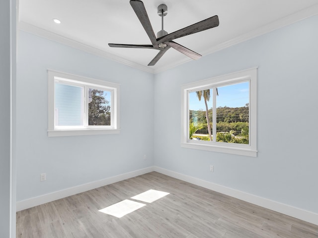 unfurnished room featuring ornamental molding, ceiling fan, and light hardwood / wood-style flooring