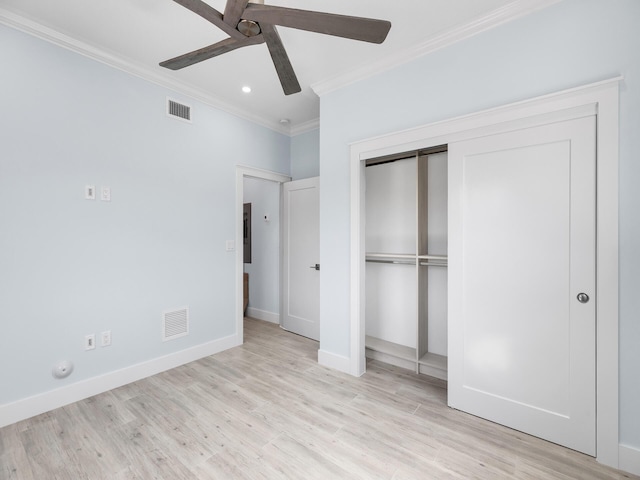 unfurnished bedroom with ceiling fan, electric panel, ornamental molding, light hardwood / wood-style floors, and a closet