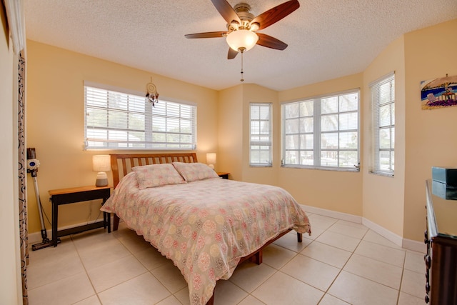 306 N Anglers Dr Unit B, Marathon, FL 33050 - bedroom with light tile patterned floors, a textured ceiling, and a ceiling fan