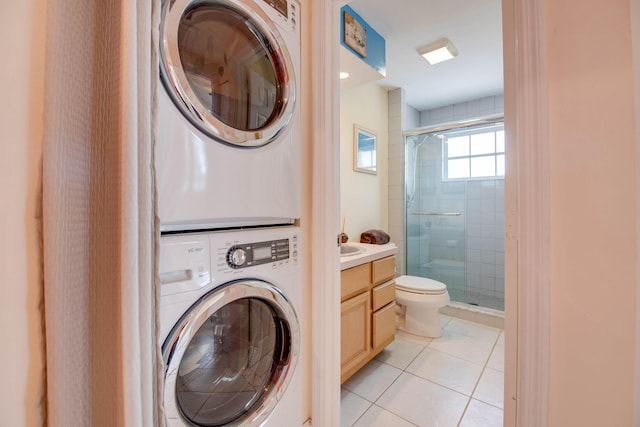 306 N Anglers Dr Unit B, Marathon, FL 33050 - washroom with stacked washing machine and dryer and light tile patterned floors