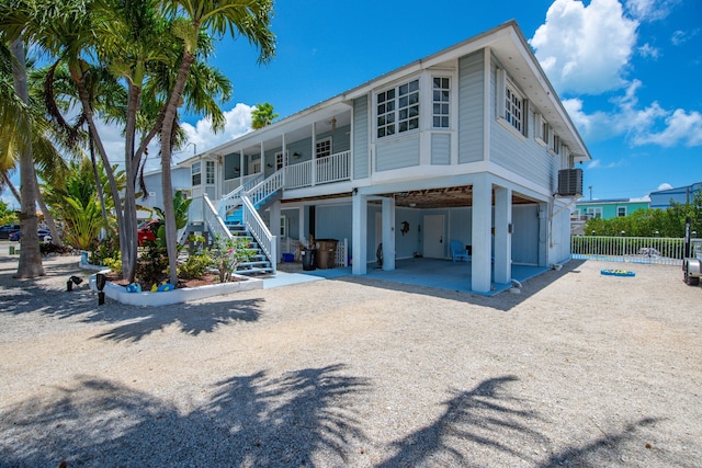 306 N Anglers Dr Unit B, Marathon, FL 33050 - rear view of property featuring stairs, a carport, and a porch
