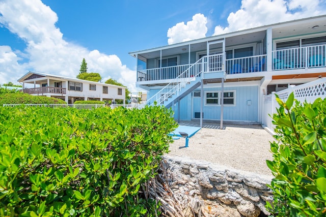 306 N Anglers Dr Unit B, Marathon, FL 33050 - rear view of house featuring stairs, board and batten siding, and a sunroom