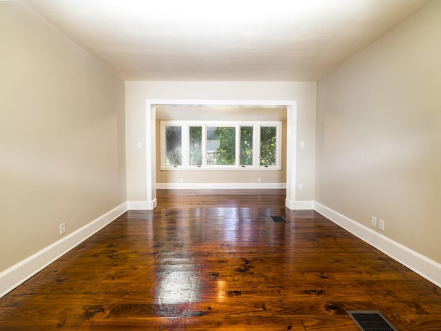 unfurnished room with dark hardwood / wood-style floors