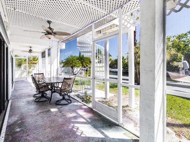 sunroom / solarium featuring ceiling fan