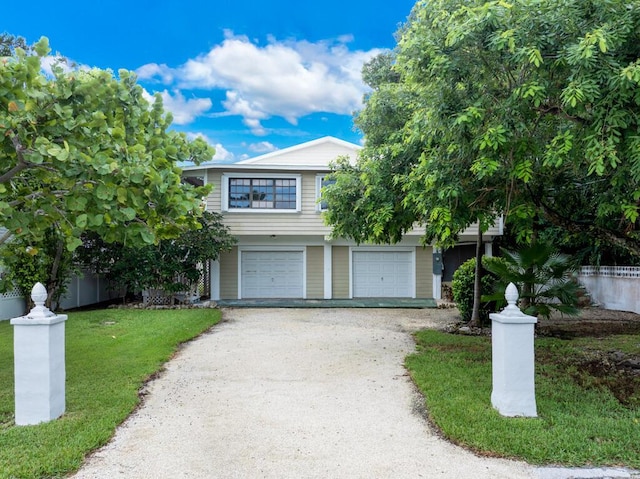 view of front of property featuring a garage and a front yard