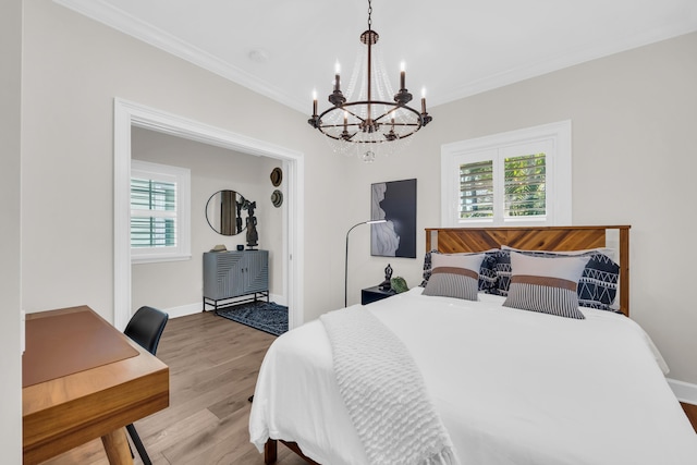 bedroom with multiple windows, ornamental molding, and hardwood / wood-style flooring