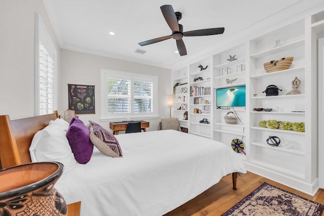 bedroom featuring crown molding, ceiling fan, and light hardwood / wood-style floors