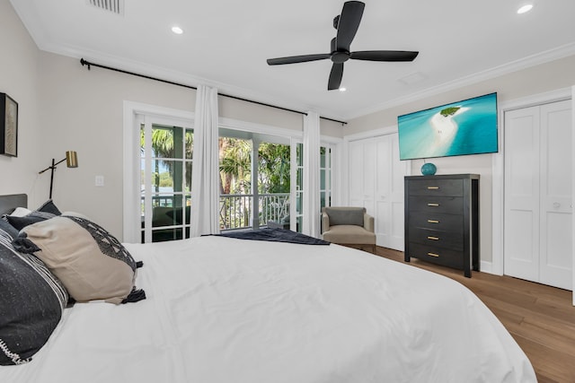 bedroom featuring crown molding, two closets, and access to exterior