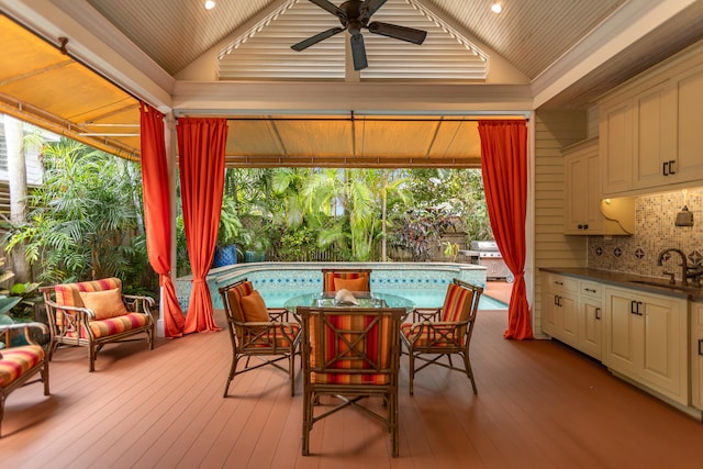 exterior space featuring ceiling fan, a swimming pool, a sink, and outdoor dining space