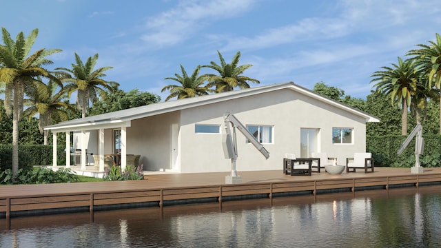 rear view of property with a deck with water view