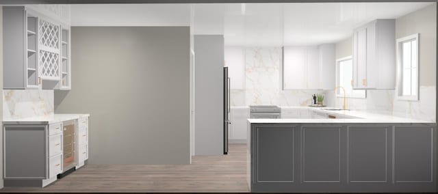 30 Key Haven Rd, Key Haven, FL 33040 - kitchen featuring a sink, light wood finished floors, decorative backsplash, and gray cabinetry