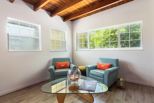 sitting room featuring beamed ceiling, wood-type flooring, a wealth of natural light, and wooden ceiling