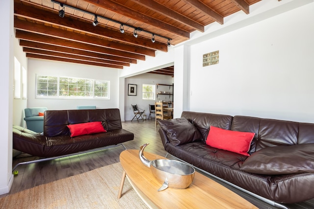 living room featuring beamed ceiling, dark hardwood / wood-style flooring, track lighting, and wood ceiling