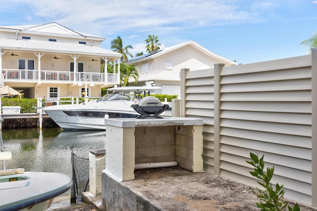 view of patio / terrace featuring a water view and ceiling fan