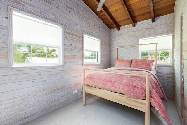 bedroom featuring lofted ceiling with beams, wooden walls, wooden ceiling, and multiple windows